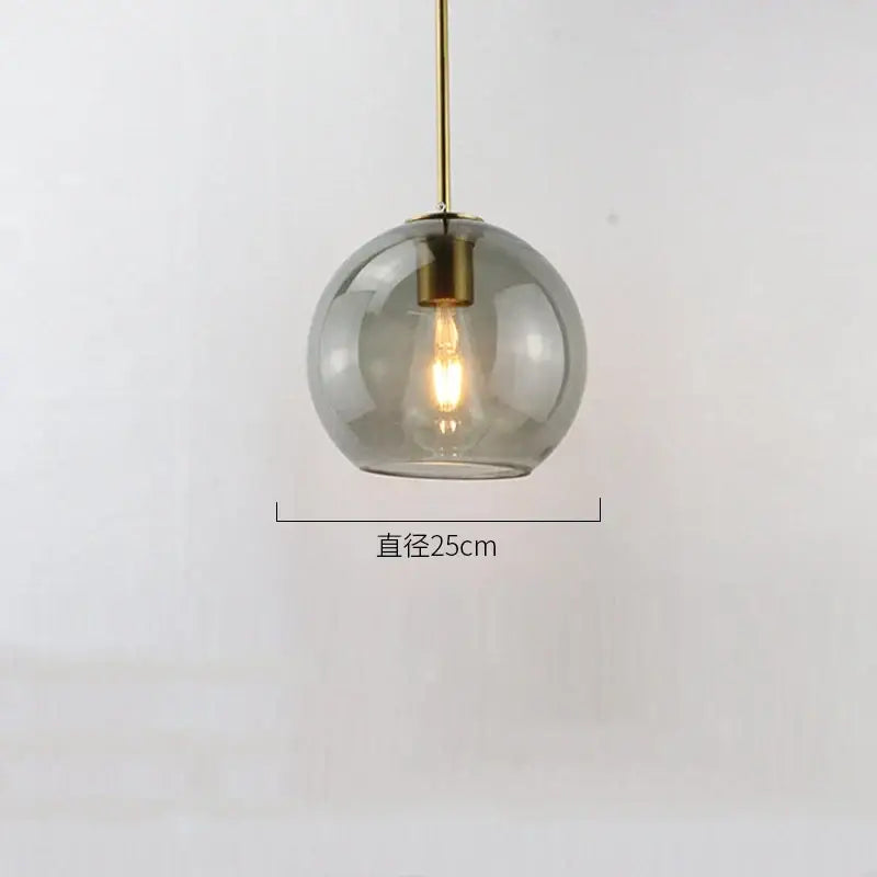 Modern amber smoked gray glass ball led pendant lights with brass rod and exposed filament bulb for dining room decorbites