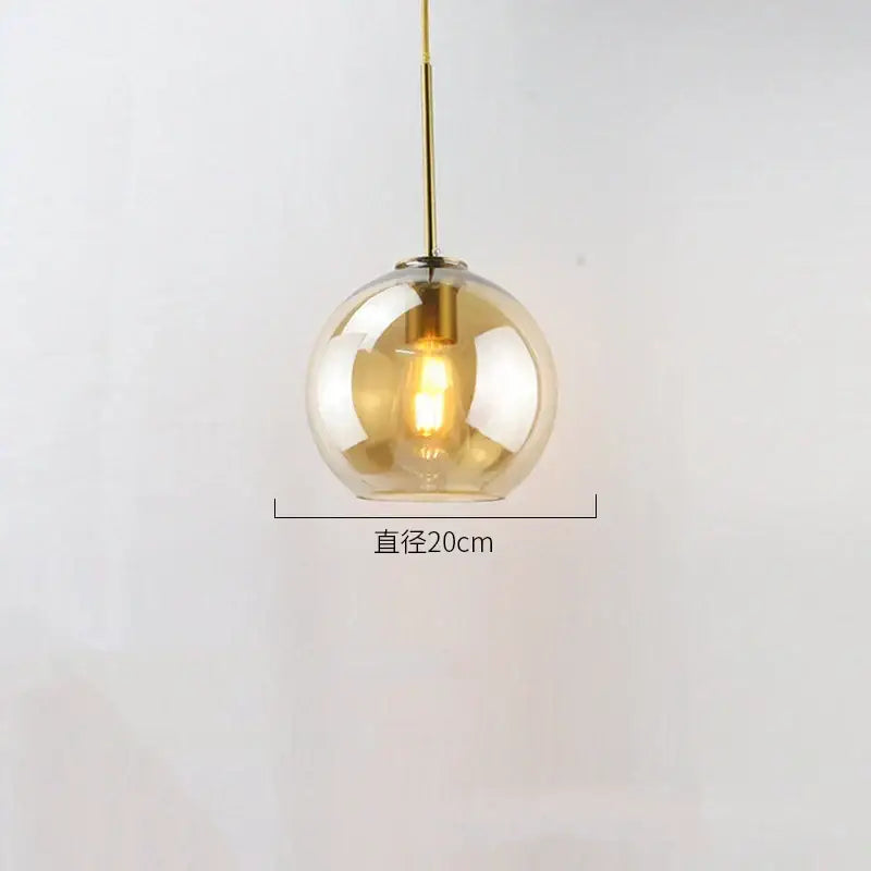 Modern amber glass ball led pendant light with brass rod and exposed filament bulb ideal for dining room decorbites