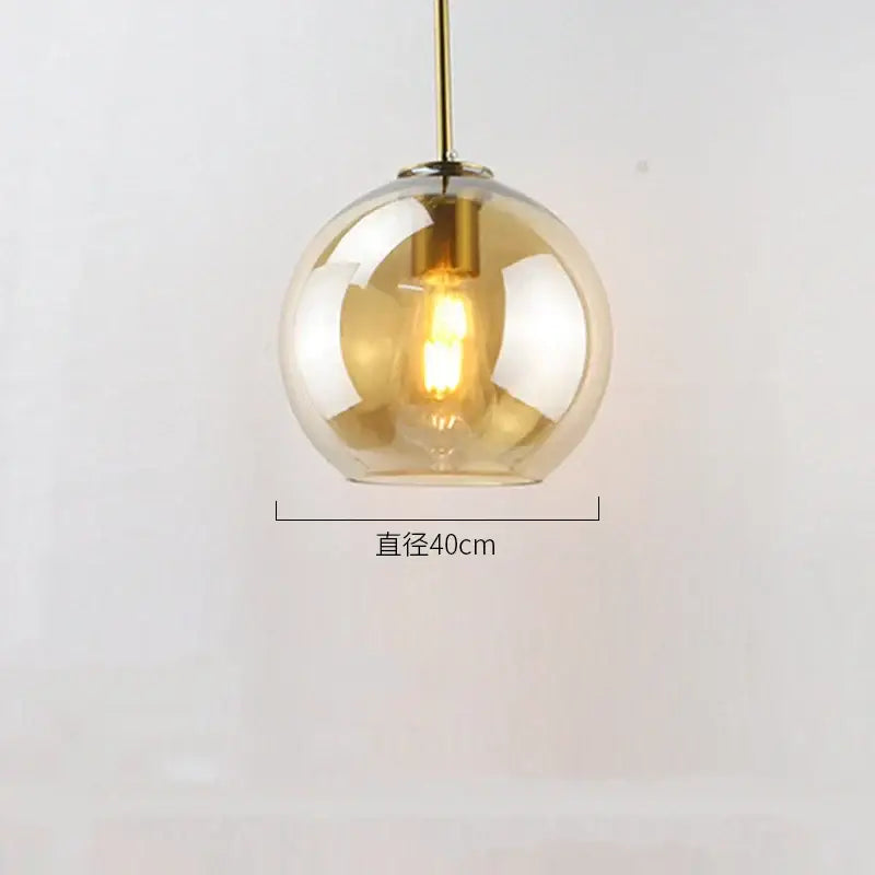 Modern amber glass ball led pendant light with brass fixture and exposed filament bulb for dining room decorbites glass ball