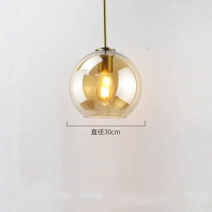 A spherical amber glass ball led pendant light with brass fixture ideal for dining room decorbites glass ball pendant lights