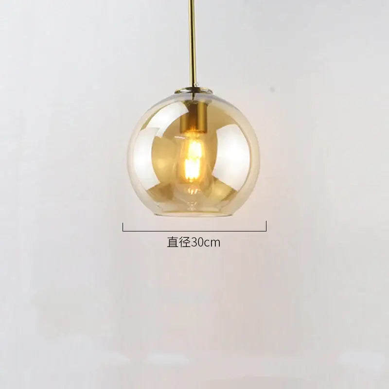 A spherical amber glass ball led pendant light with brass fixture ideal for dining room decorbites glass ball pendant lights