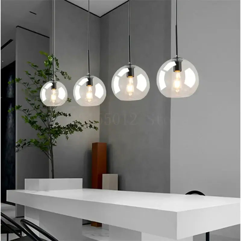 Four modern amber smoked gray and clear glass ball led pendant lights with exposed filament bulbs for dining room decorbites glass ball pendant lights