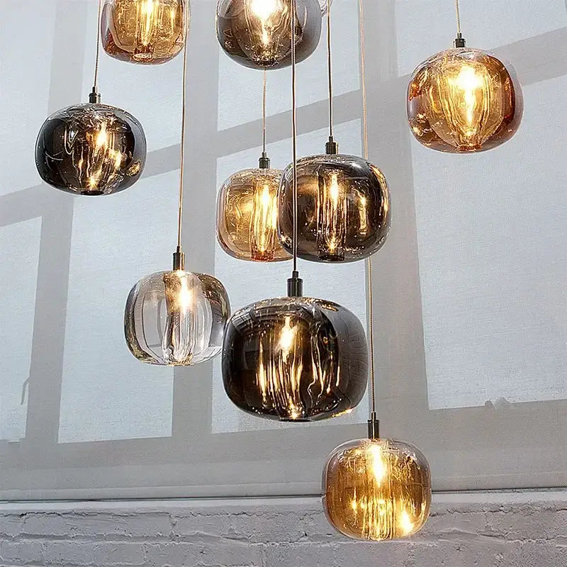 Modern amber and smoky grey crystal staircase chandelier with spherical glass pendant lights for dining room