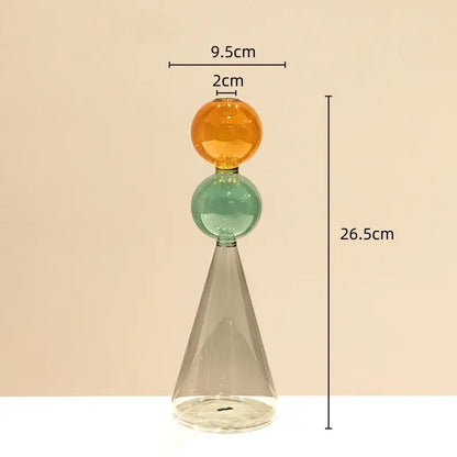A modern stained glass vase with double glazing featuring amber and teal orbs on a clear conical base for living room decor