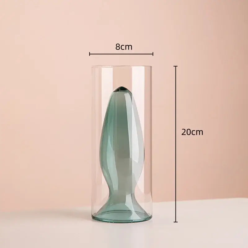 A sleek translucent teal glass vase with a modern silhouette for living room decor in double glazing stained glass