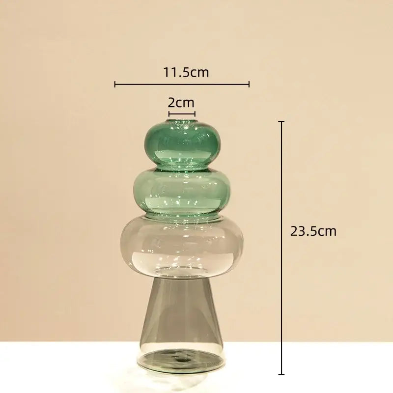 A modern translucent green glass vase with stacked rounded tiers and flared base for double glazing stained decor