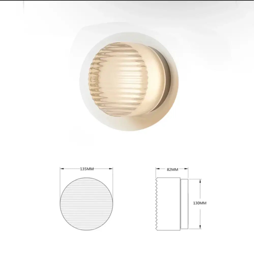 Cream-colored circular recessed sconce led wall lamp with textured ribbed glass diffuser and metallic trim for living room