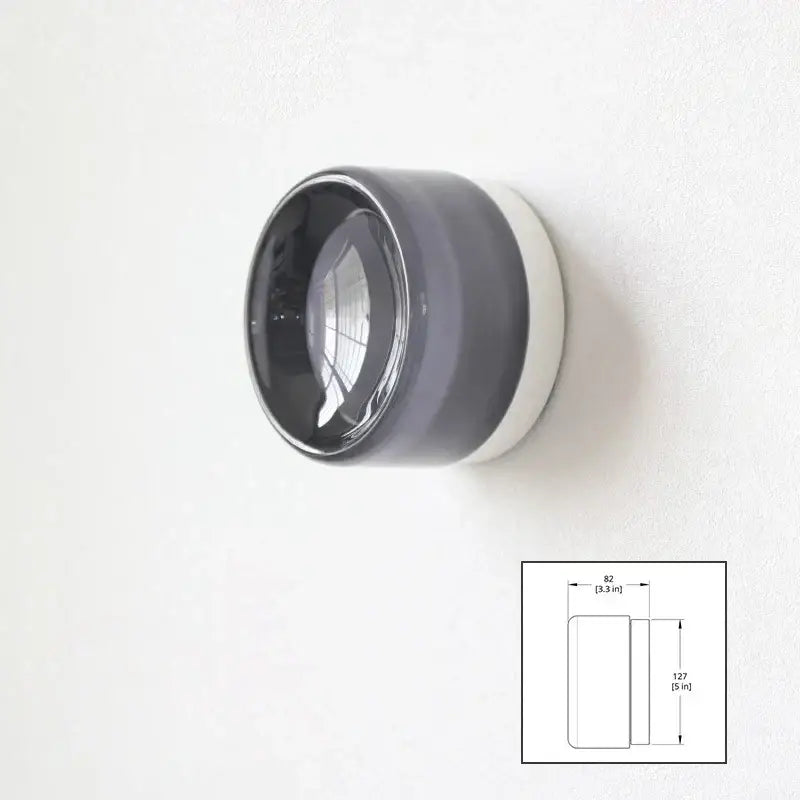 A sleek modern amber and white glass sconce led wall lamp with a glossy dark gray ceramic body for living room