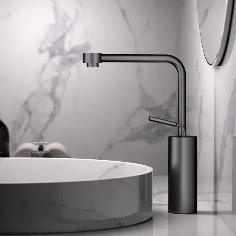 Modern antique bronze curved brass faucet with a sleek matte black cylindrical base for bathroom fixtures