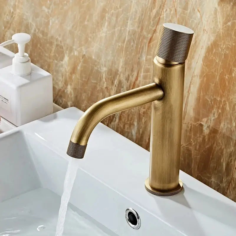 Antique bronze single-handle bathroom faucet with textured knurled accents for cold water use