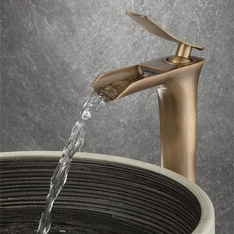 Modern antique bronze waterfall mixer faucet with brass finish and sleek design for bathroom cold water use