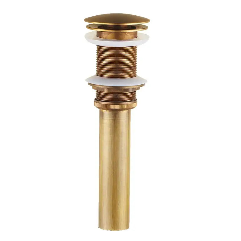 Brass-colored cylindrical bathroom sink drain with fluted top and white seals for antique bronze cold water faucet