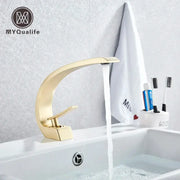 Modern arched brushed gold basin faucet with a sleek metallic finish and minimalist design for bathroom use