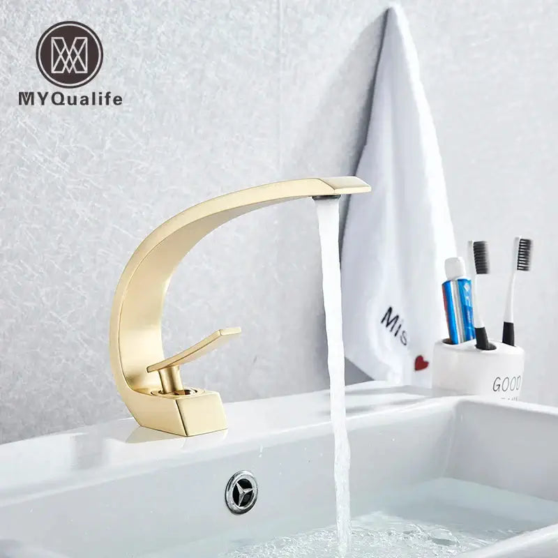 Modern arched brushed gold basin faucet with a sleek metallic finish and minimalist design for bathroom use