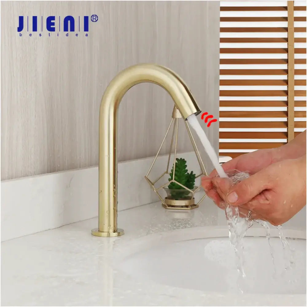 Modern arched brushed gold basin faucet with sleek metallic finish and integrated sensor technology for bathroom use decorbites brushed gold
