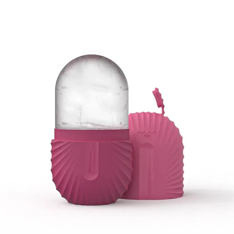 Modern arched pink marble facial roller massager with a pink silicone clamshell-shaped ice cube pack and clear marble dome