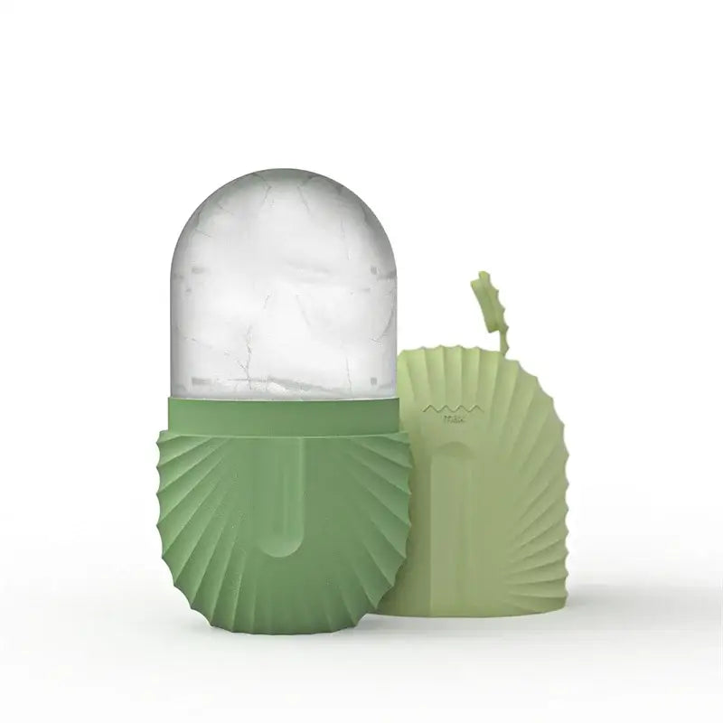 A sleek lime-green silicone ice cube tray with a transparent dome top and fluted base for facial roller massager use