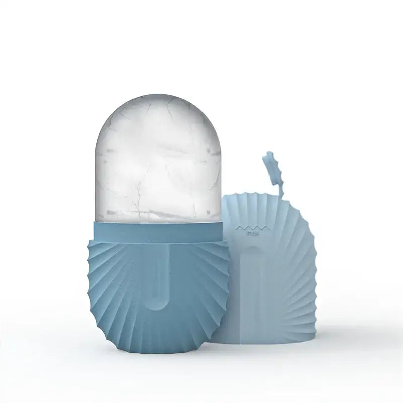 A sleek light blue silicone ice cube with a translucent dome and fluted shell designed for facial roller massager use
