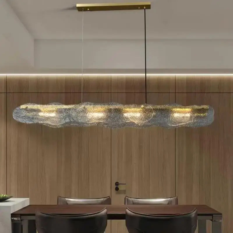 Modern art glass dining table chandelier featuring elongated textured glass and gold-toned decorbites art glass accents