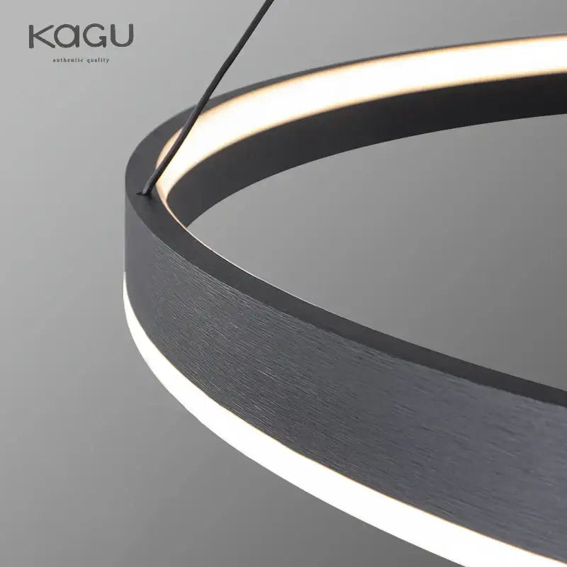 Modern artistic black chandelier featuring a circular pendant light with brushed metal finish and warm led ring lighting by decorbites artistic black
