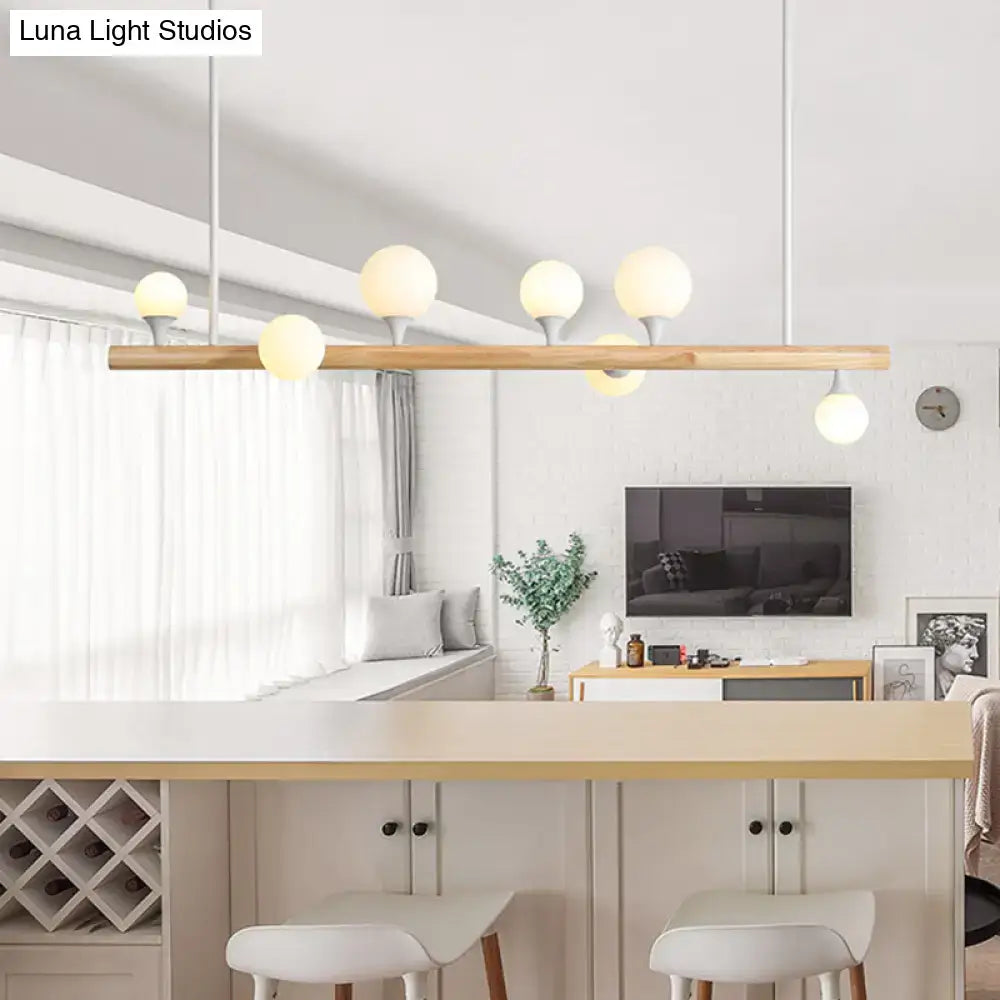 Modern asian wood hanging ceiling light with natural wood bar and six frosted glass globe bulbs for dining room