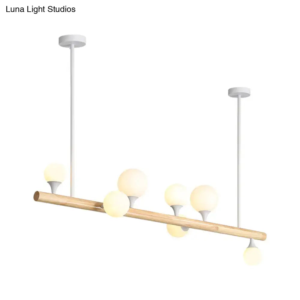 Modern asian wood hanging ceiling light with natural wood rod and five frosted glass globe bulbs for dining room