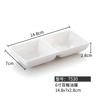 White ceramic two-compartment serving dish with minimalist design paired with decorbites black melamine dipping sauce bowls