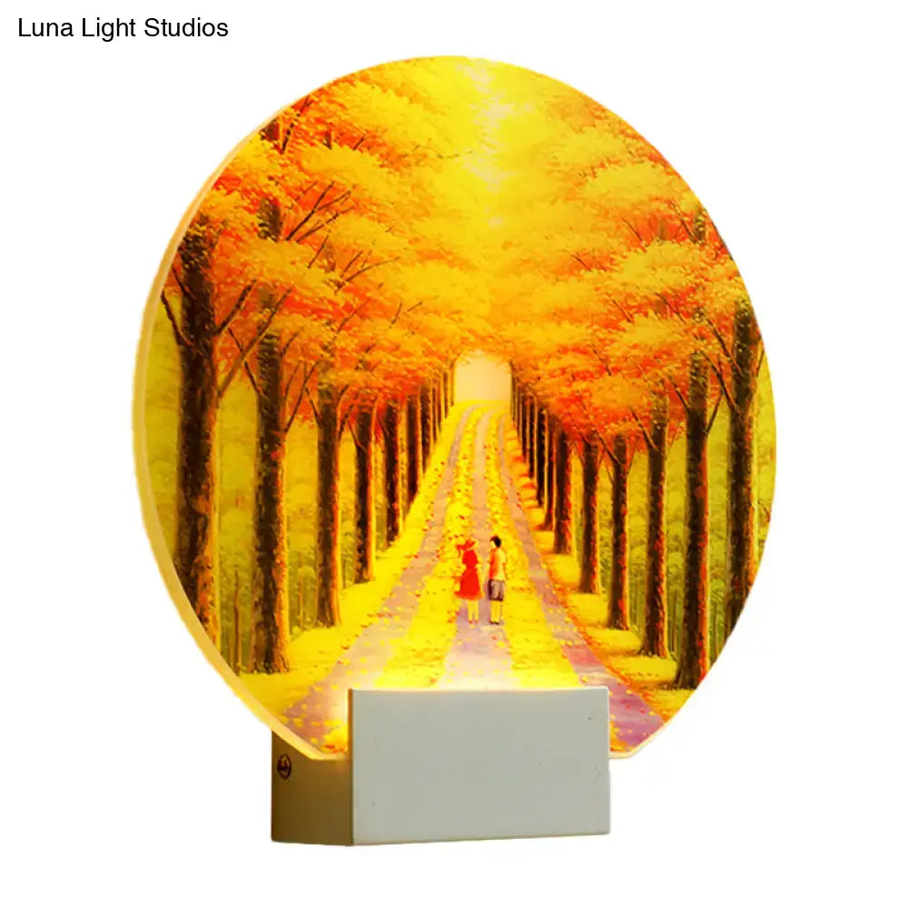 Modern autumn forest acrylic wall lamp glowing with warm hues featuring two figures with fixture height 12in