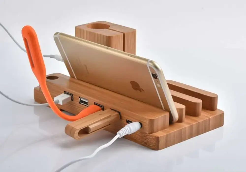 A sleek modern bamboo base 3-in-1 charging stand with usb ports and built-in orange led lamp for bedroom use