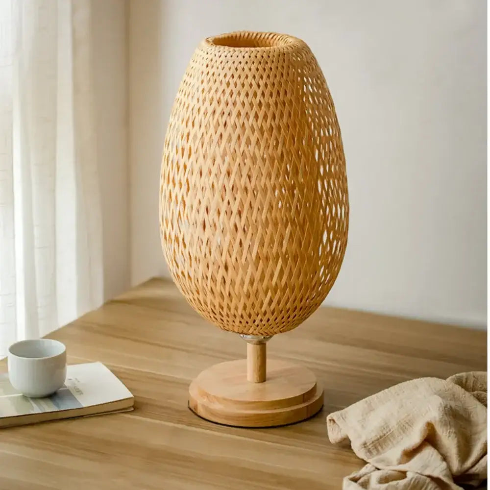 Modern bamboo weave table lamp with natural-toned rattan diamond-patterned body and wooden base for bedroom use