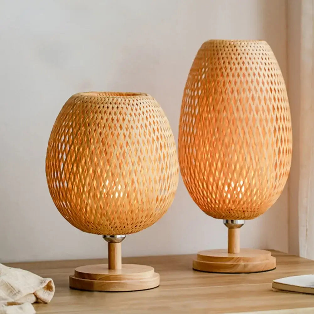 Two woven bamboo weave table lamps with warm natural finish and intricate diamond-patterned mesh design for bedroom use
