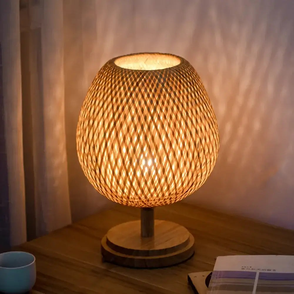 Warm-toned bamboo weave table lamp with circular base ideal for modern bedroom lighting and decor