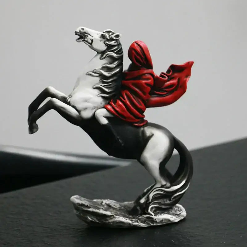 Silver and black horse figurine with a flowing red cloak in a modern red knight statue for living room decor