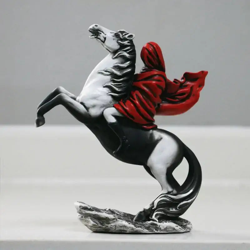 A modern red knight statue featuring a dynamic black and white horse with a flowing red cloak made of glossy resin
