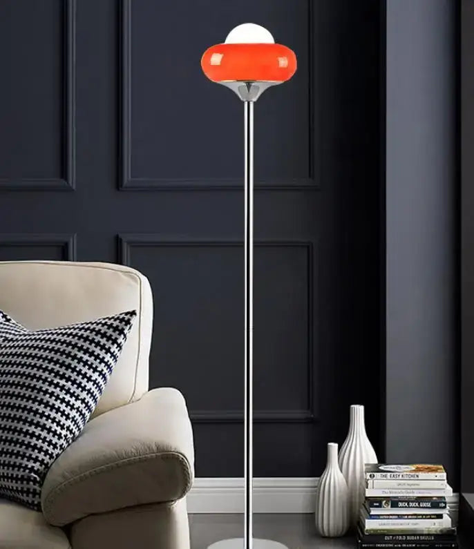 A sleek modern bauhaus table lamp with a vibrant yellow and white glass shade on a slender chrome pole by guzzini modern