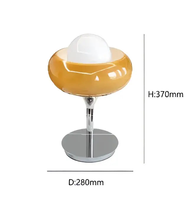 A modern bauhaus table lamp with a glossy amber guzzini modern glass base and white spherical shade for bedroom decor