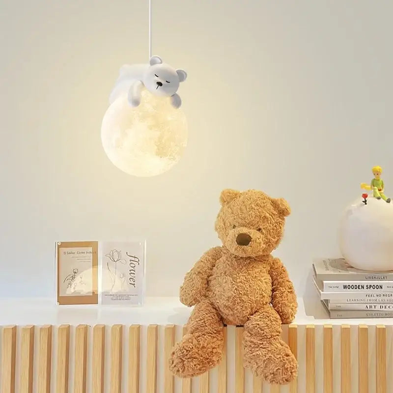 A soft tan teddy bear with brown nose on wooden shelf beside modern bear led pendant light bedroom chandelier