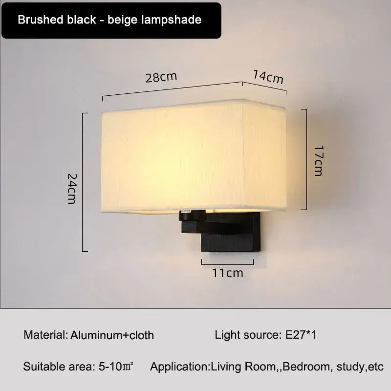 Brushed black wall lamp with rectangular beige fabric shade for an elegant bedroom wall lamp setup