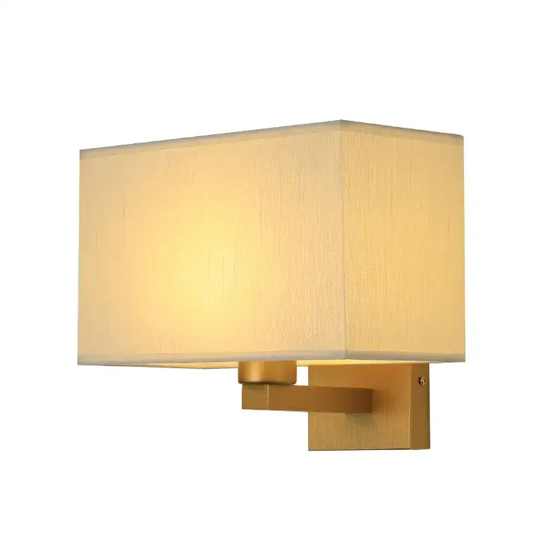 Gold-finished rectangular wall lamp with a soft beige fabric shade for an elegant bedroom wall lamp design