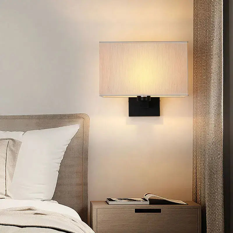 Modern beige and black elegant bedroom wall lamp with rectangular wall lamp featuring a textured fabric shade and metal base