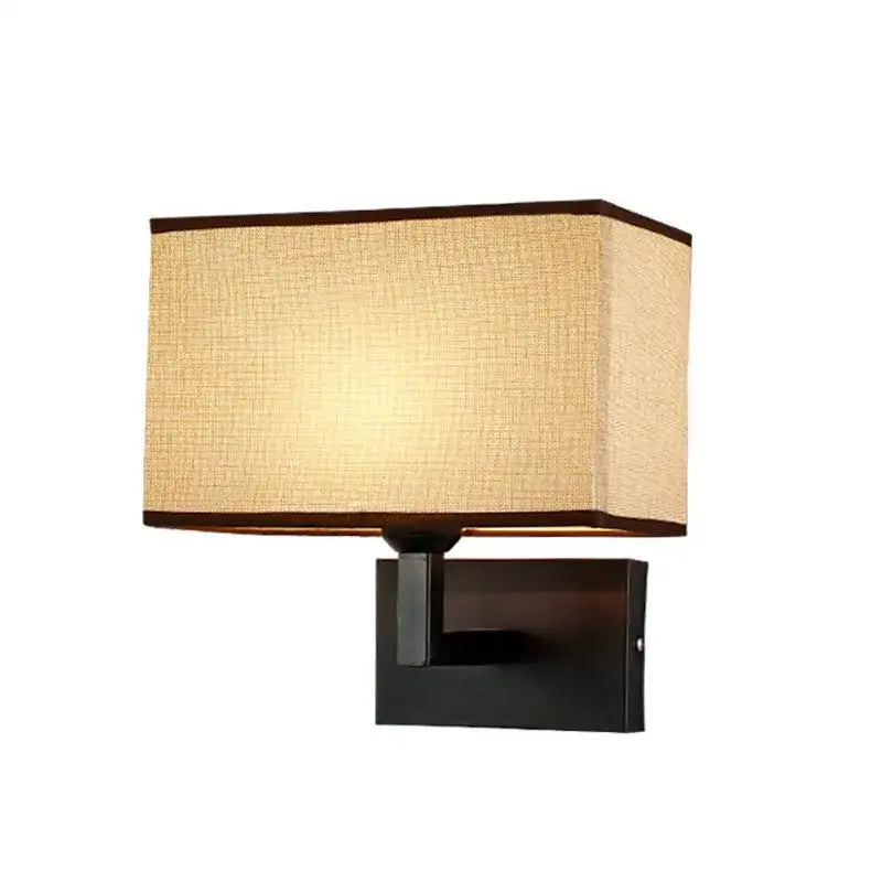 Modern beige and brown decorbites hotel fabric wall lamp with dark trim on matte black metal fixture for bedroom decor