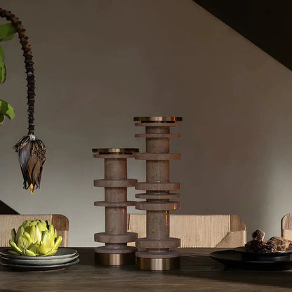 Two tiered modern beige and brown travertine candle holder with metal base and brushed brass accents for dining room decorbites