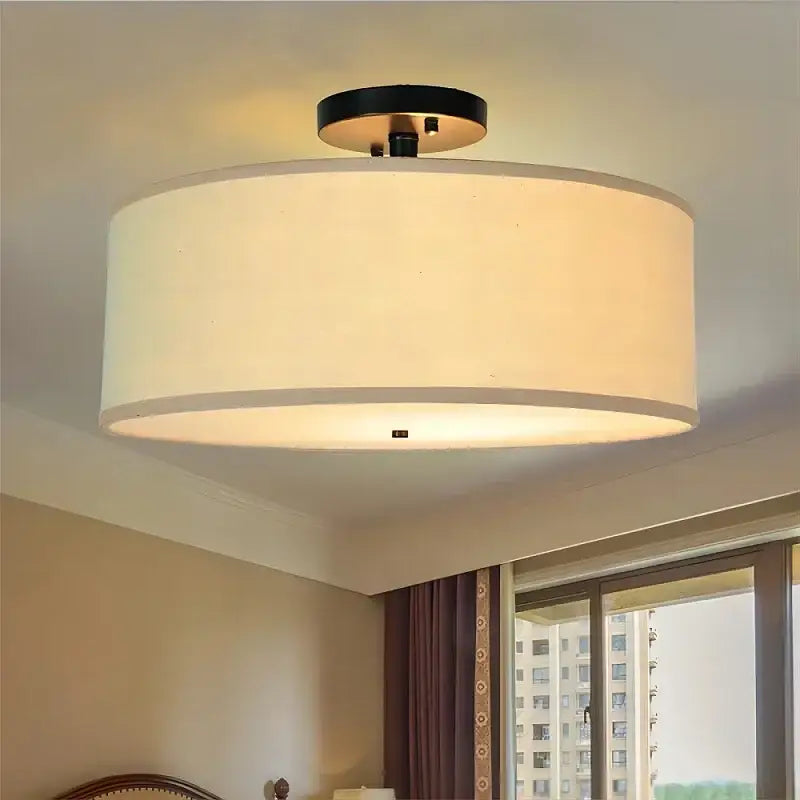 Cream-colored decorbites country fabric led ceiling light with black metal base and fabric shade for dining room