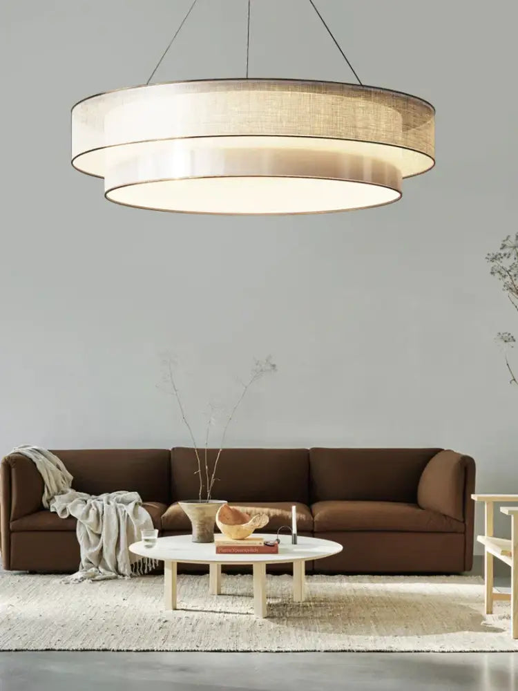 Modern beige fabric pendant light with layered linen shade and metallic ring for dining room decorbites contemporary led round