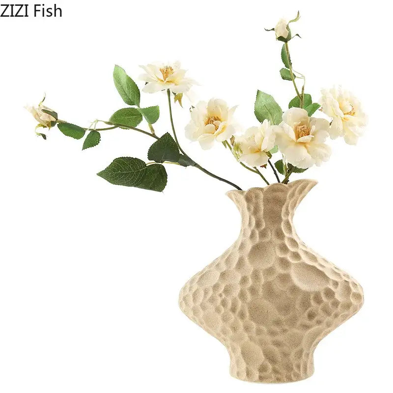 Modern beige frosted ceramic vase with textured hammered pattern and slender neck holding cream roses decorbites frosted ceramic