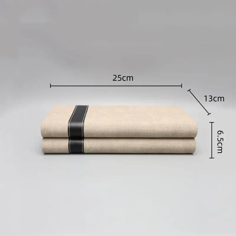 Beige linen napkins with a black leather strap complementing decorbites geometric jewelry storage box and bedroom organizer