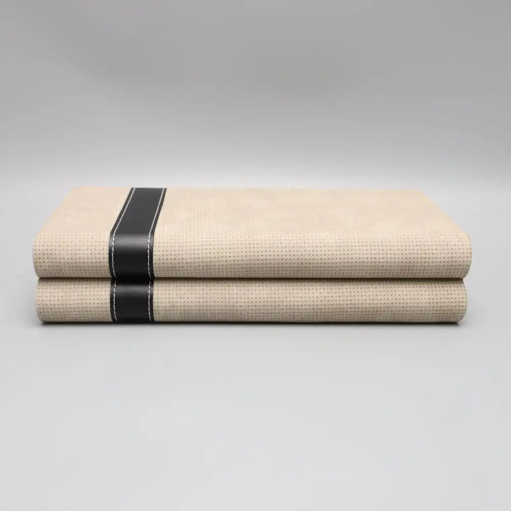 Modern beige geometric jewelry storage box with textured fabric and black leather straps for jewelry storage