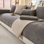 Beige and gray chenille textured throw blanket draped over a modern sectional sofa for living room comfort