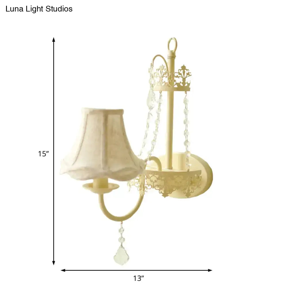 Cream-colored ornate crystal sconce with fabric lampshade and crystal beads 15 inch fixture for modern bedroom use