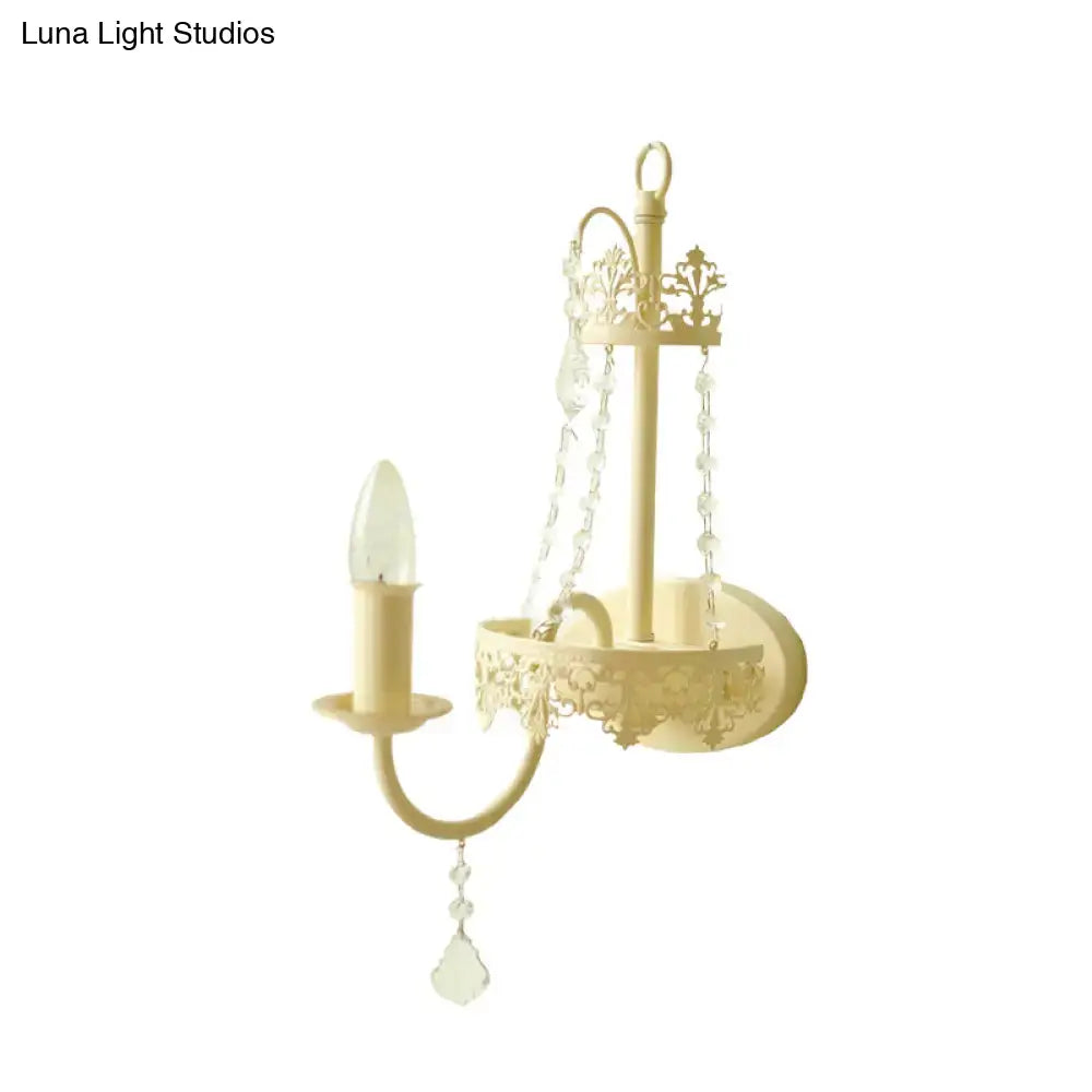 Cream-colored wrought iron wall sconce with ornate scrollwork and crystal beads modern beige 15 inch fixture